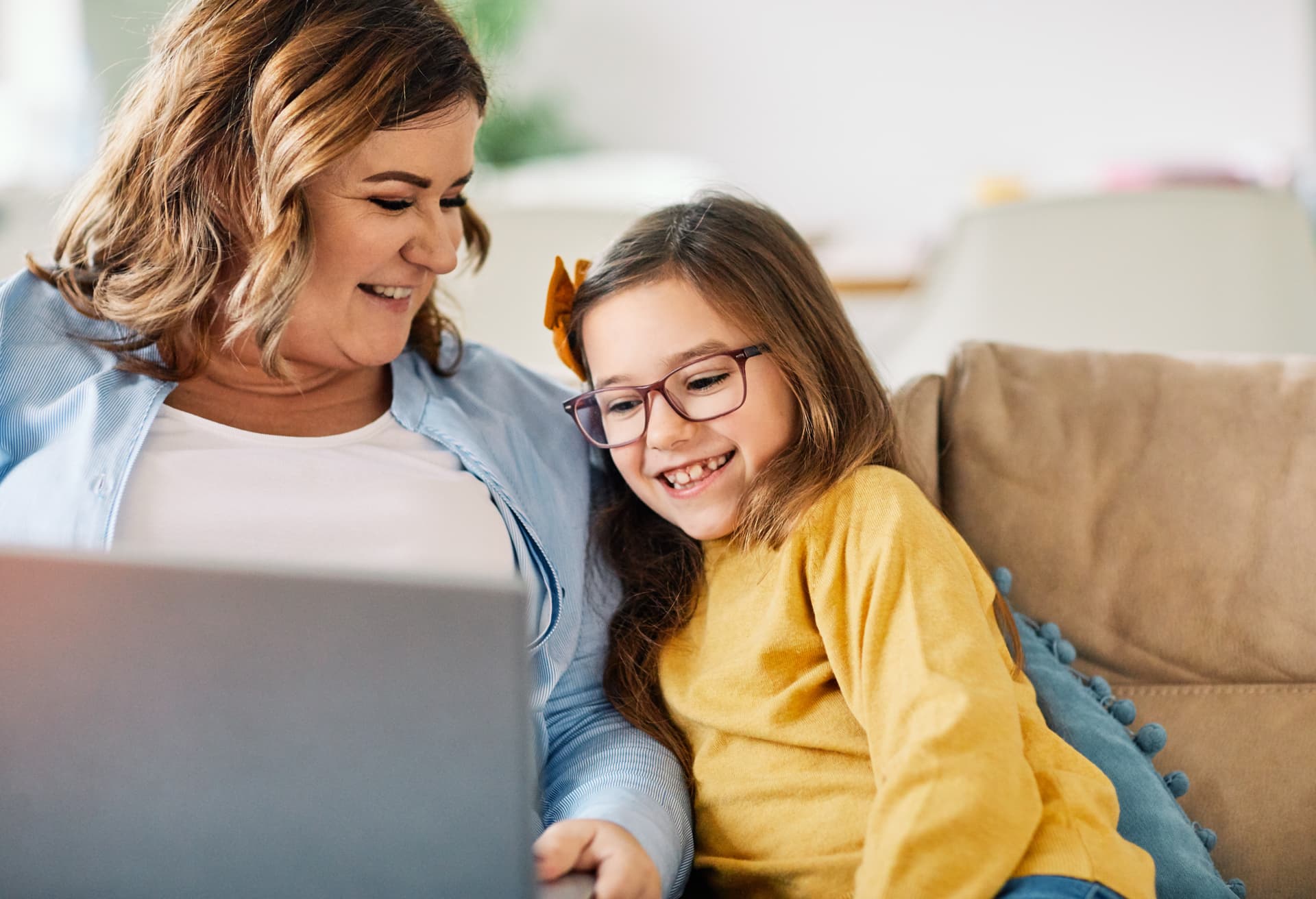 Mother and daughter using laptop together